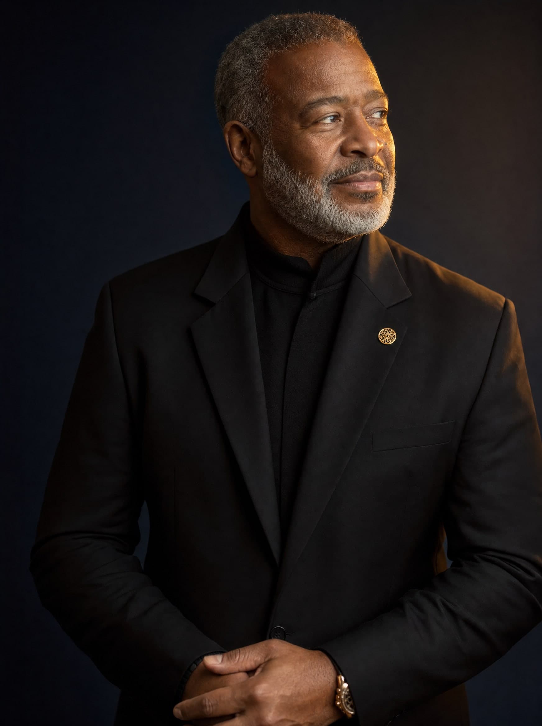 A distinguished gentleman in a sharp all-black ensemble